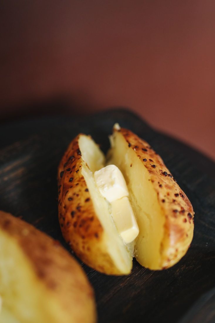 A baked potato with a soft topping