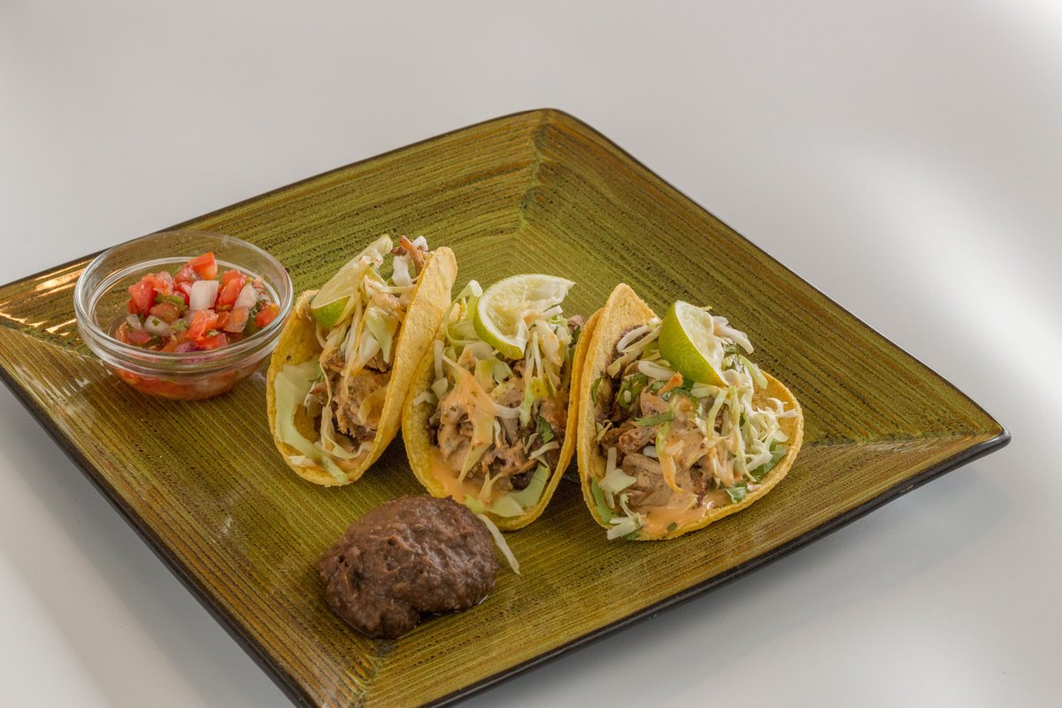 Tacos served with refried beans and salsa